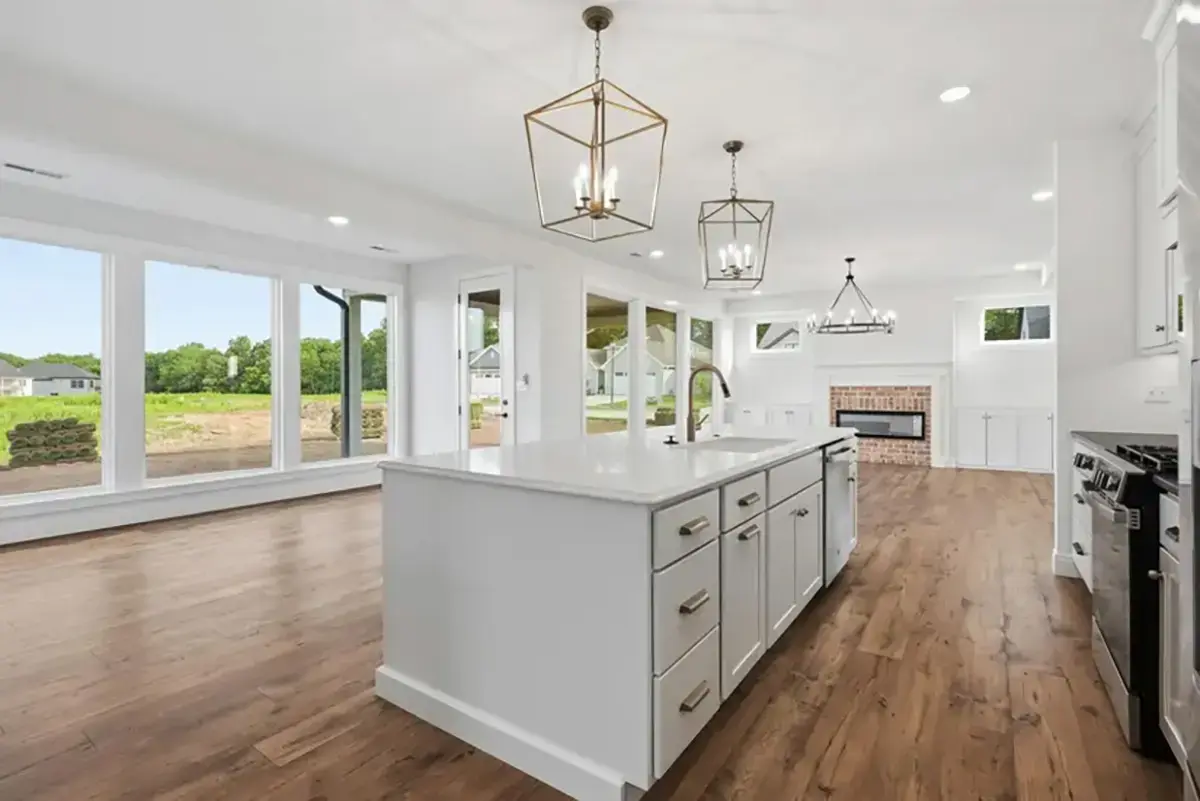 White Kitchen and living area with bay windows, and wood floors